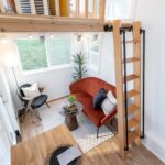Compact tiny house living space with modern decor and natural light.