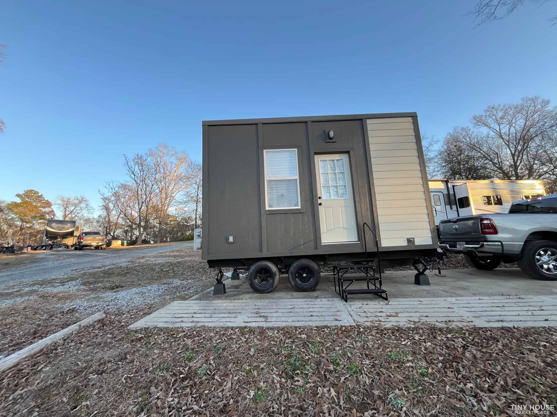 Portable tiny house with a small porch and single door, ideal for minimalist living.