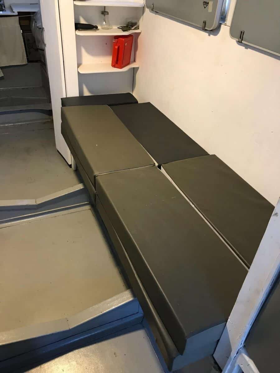 Compact tiny house interior featuring a fold-out bed for space-saving living.