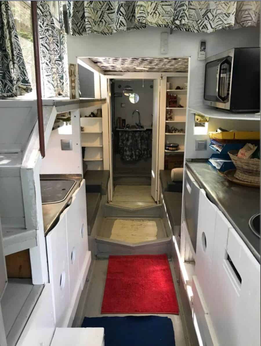 Tiny house interior with standing loft and compact kitchen space.