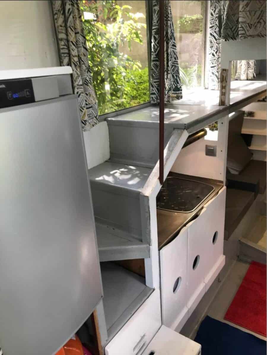 Tiny house interior with standing loft and compact kitchen space.