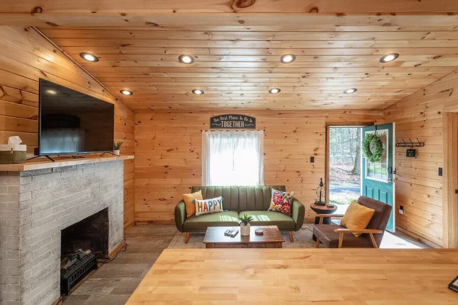 Charming tiny house living room with wooden walls, modern furniture, and natural light. Perfect for.