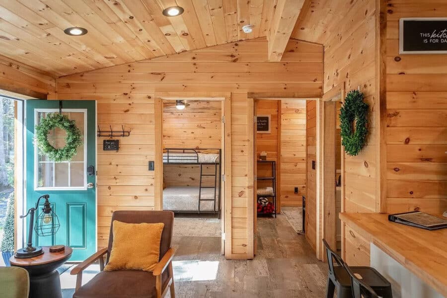Charming tiny house interior with wood accents, cozy seating, and natural light, perfect for small s.