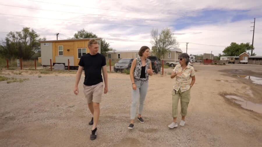 Visitors walking through New Mexico tiny house community near Rio Grande.