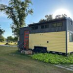Compact 24ft tiny house with modern design and loft space for small living.