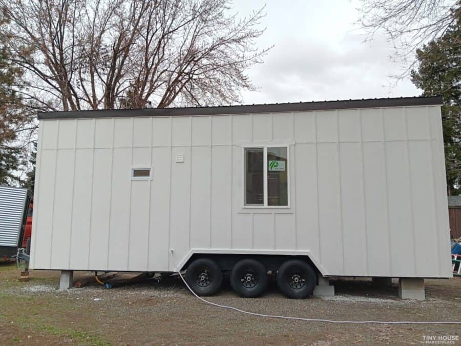 Compact tiny house on wheels with sleek exterior design.