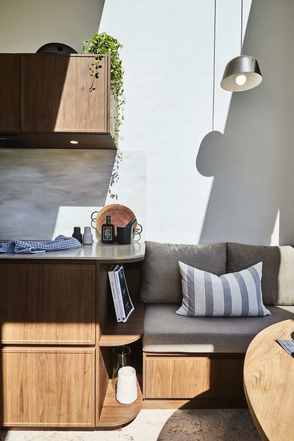 Living and dining space with built-in storage in the NOOSA tiny house