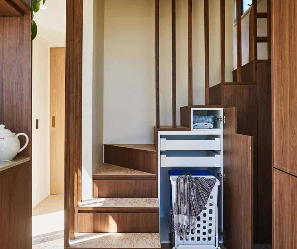 Staircase storage system with built-in drawers in the NOOSA tiny house