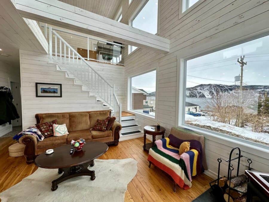 Bright interior of Nora’s Nook with panoramic mountain views and cozy furnishings.