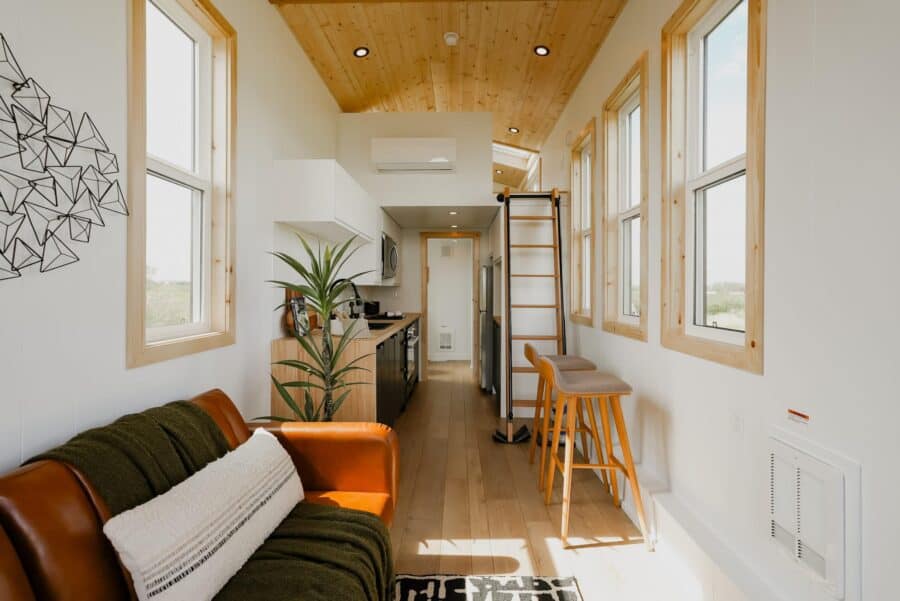 Compact tiny house living space with natural light and modern design.