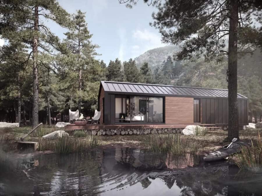 Prefab pod home with modern design and large glass windows in a forested area.