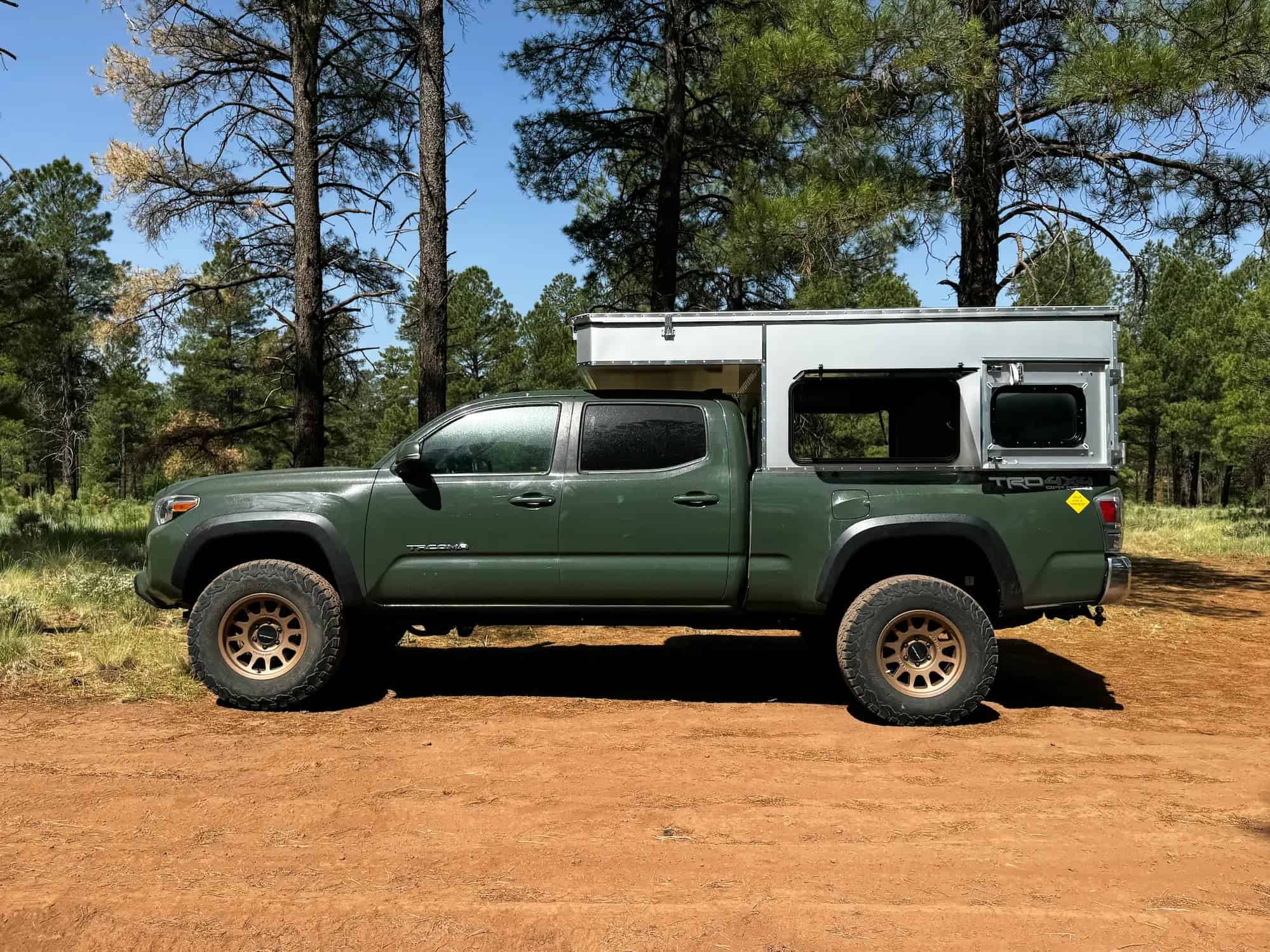 OVRLND Bread n Butter pop-top truck camper shell mounted on a pickup truck showing its low-profile design