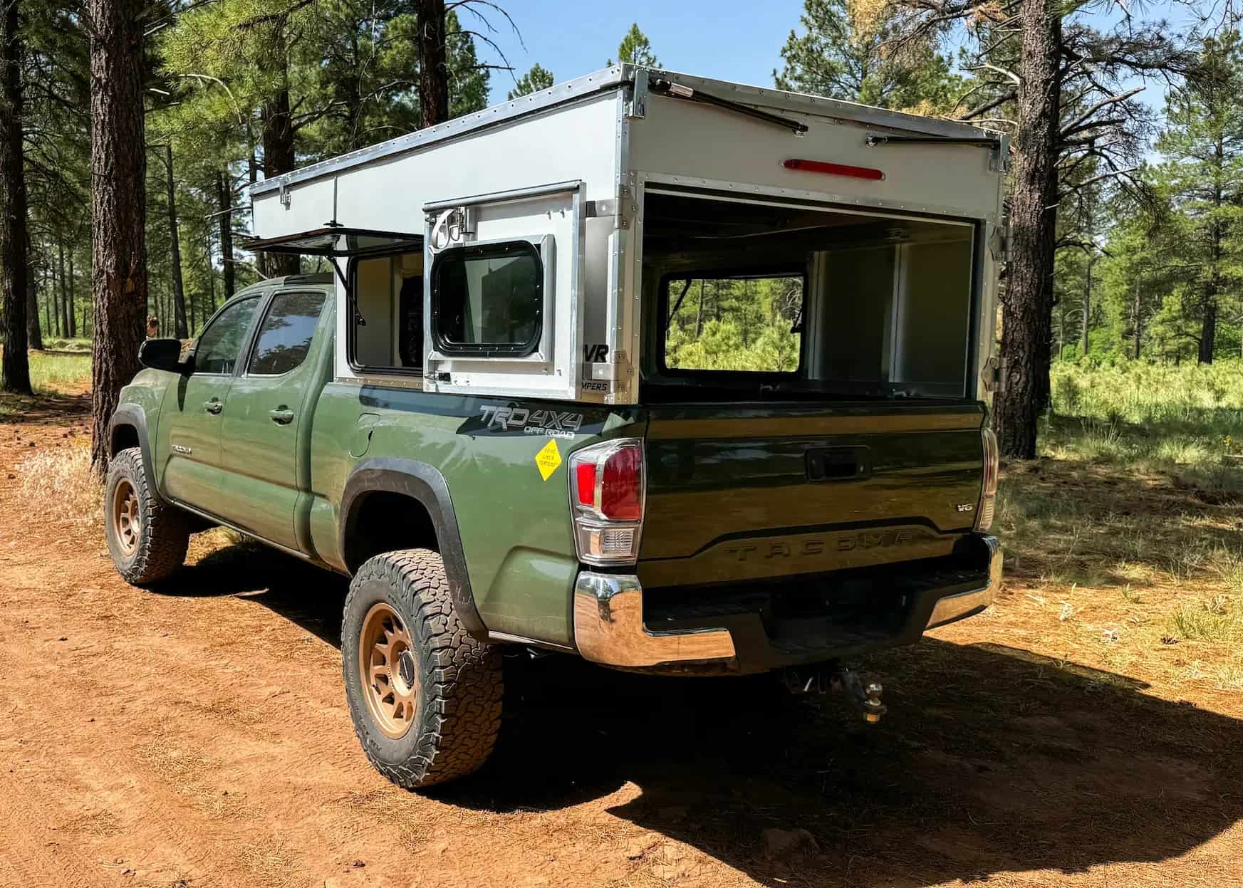 Interior view of the OVRLND Bread n Butter camper showing the queen-sized sleeping platform and windows