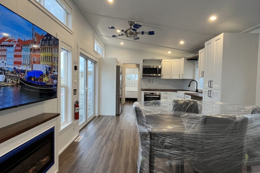 Bright tiny house interior featuring a sleek kitchen and cozy living space.
