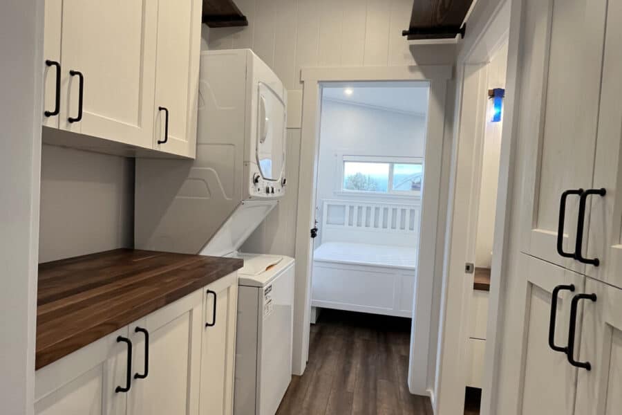 Efficient laundry space inside the 44-foot Orca Edition tiny house by Mint Tiny House Company.