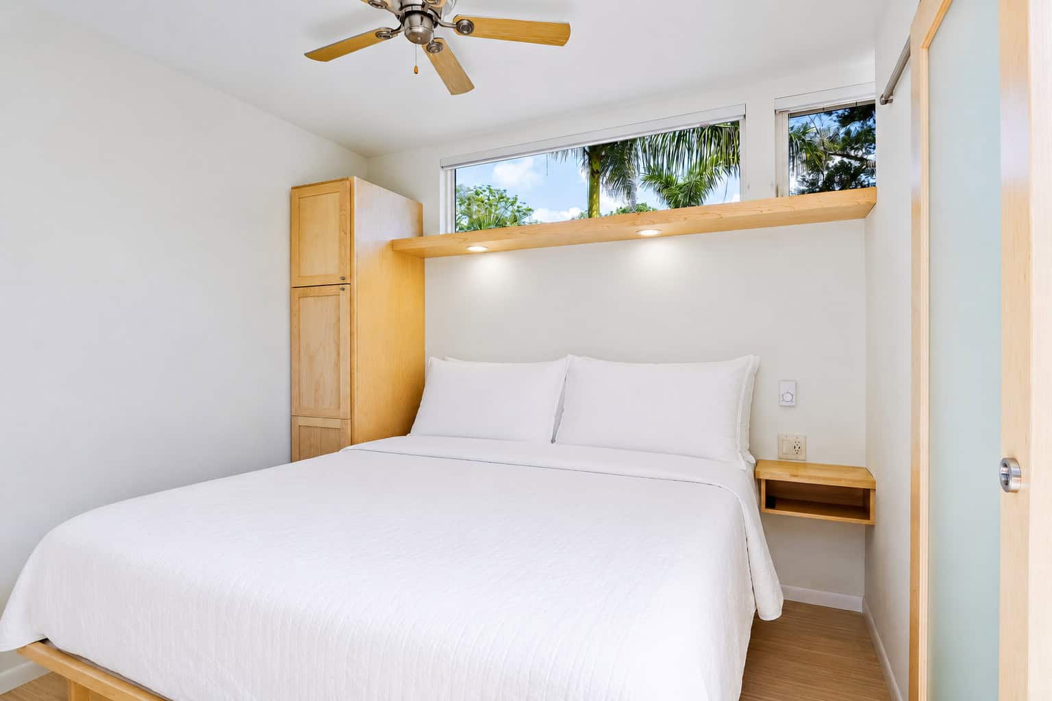 King bedroom with closet, built-in side tables and ceiling fan in the Escape N2