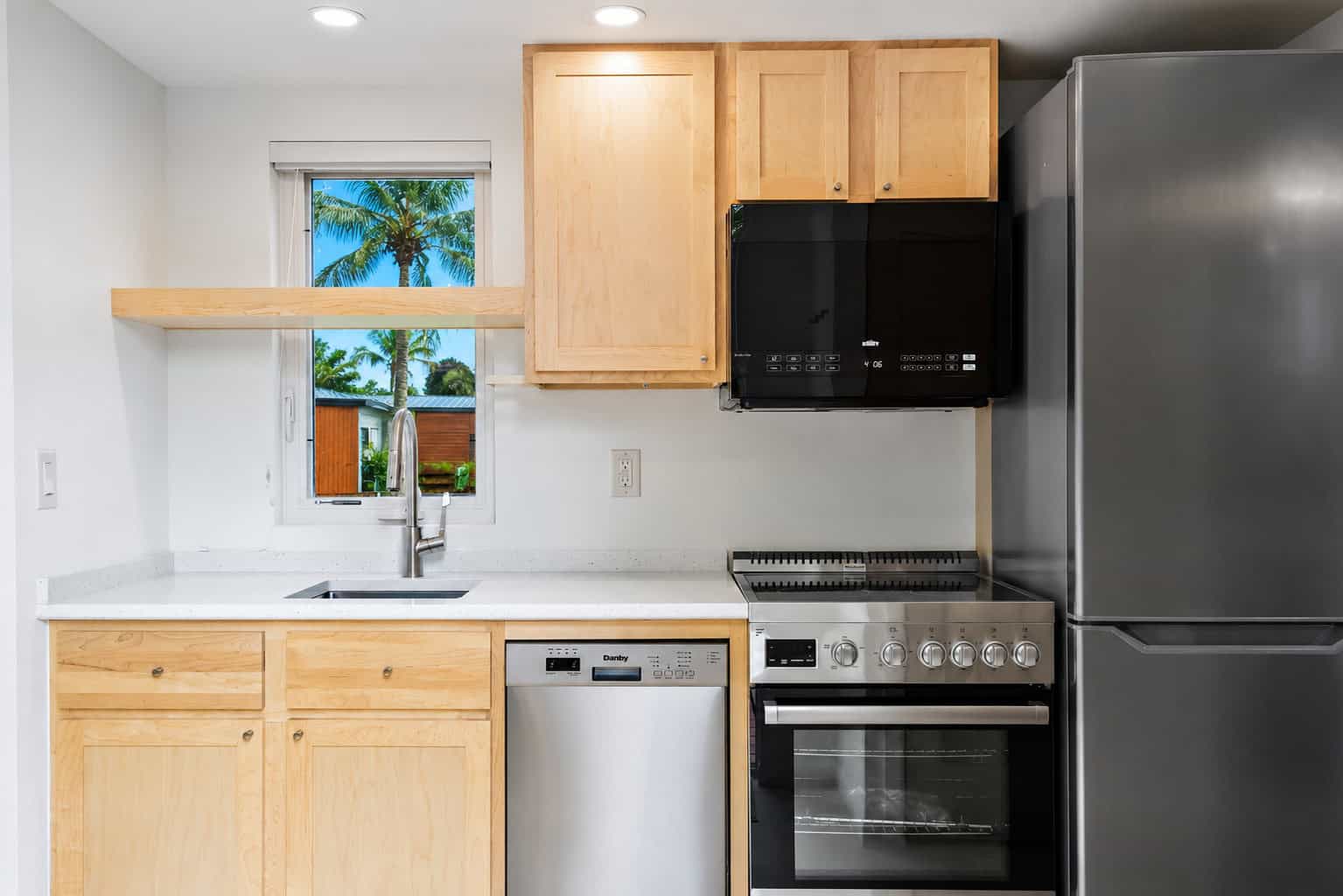 Gourmet kitchen with stone countertops, maple cabinetry, stainless appliances and dishwasher in the Escape N2