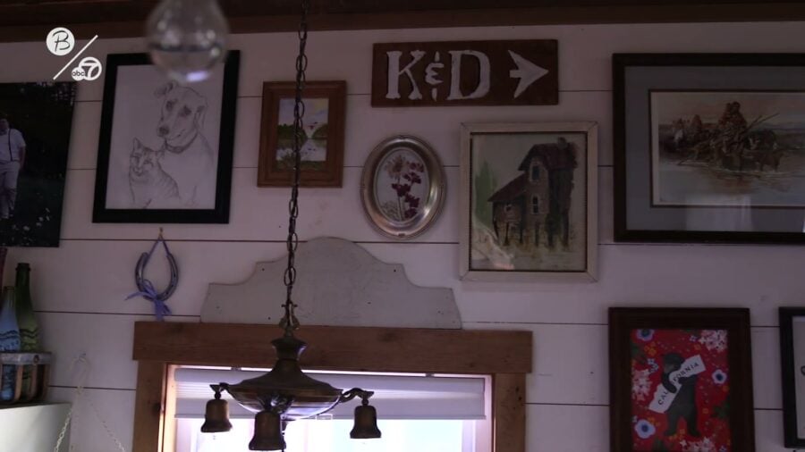 Framed art gallery wall above a window inside Derek Campbell's 350 square foot tiny house