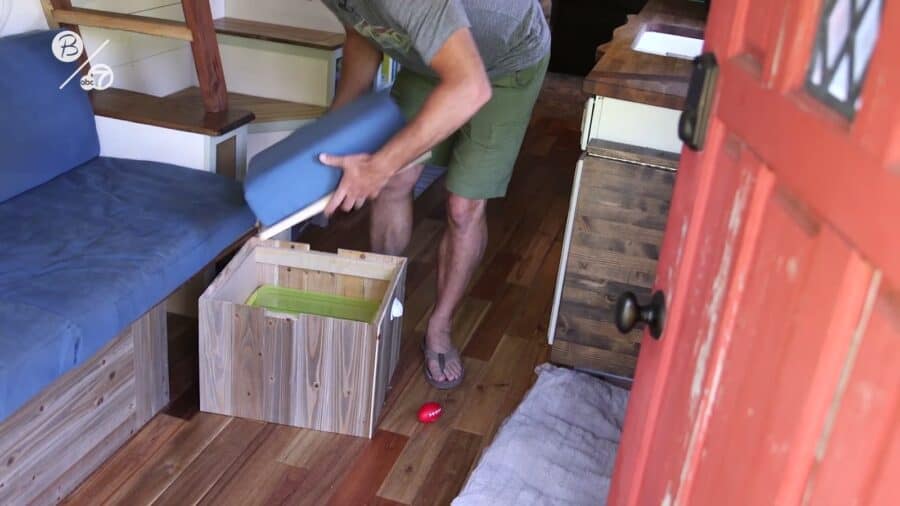 Lift-up bench seat with a hidden storage cube inside Derek Campbell's tiny house at Park Delta Bay