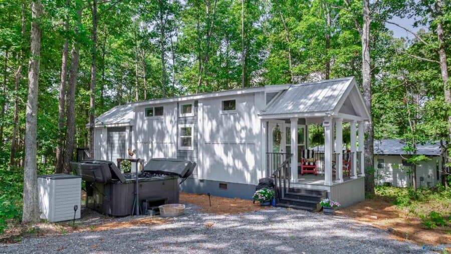 Property overview showing tiny house positioned on wooded lot