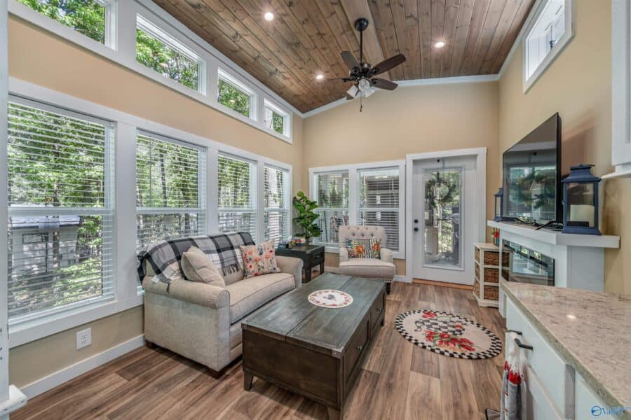 Open living and kitchen area with vaulted ceilings and natural light