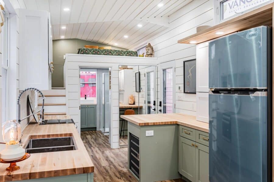 Tiny house kitchen with compact appliances and modern design.