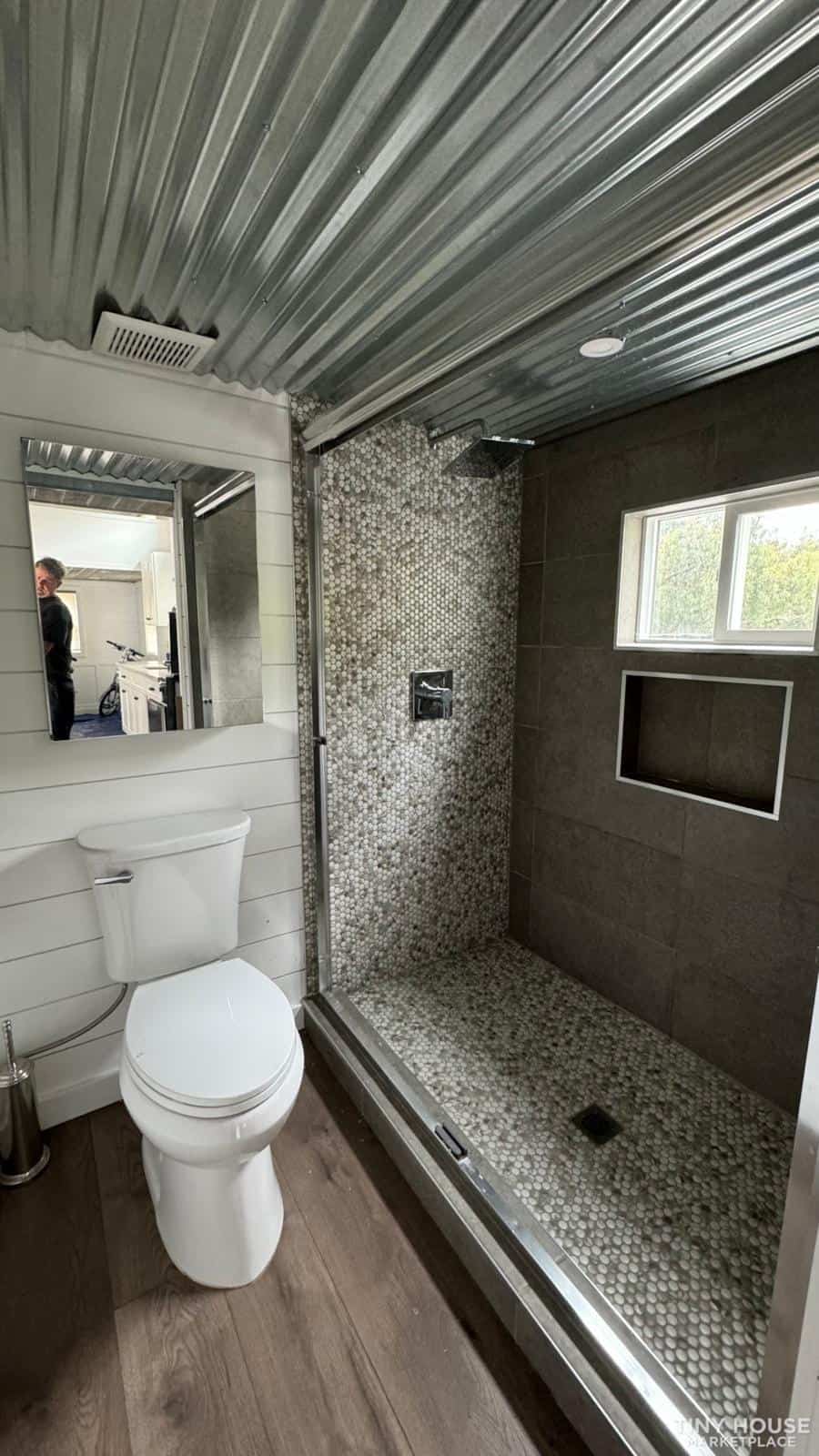 Modern tiny bathroom with sage green accents and sleek design.
