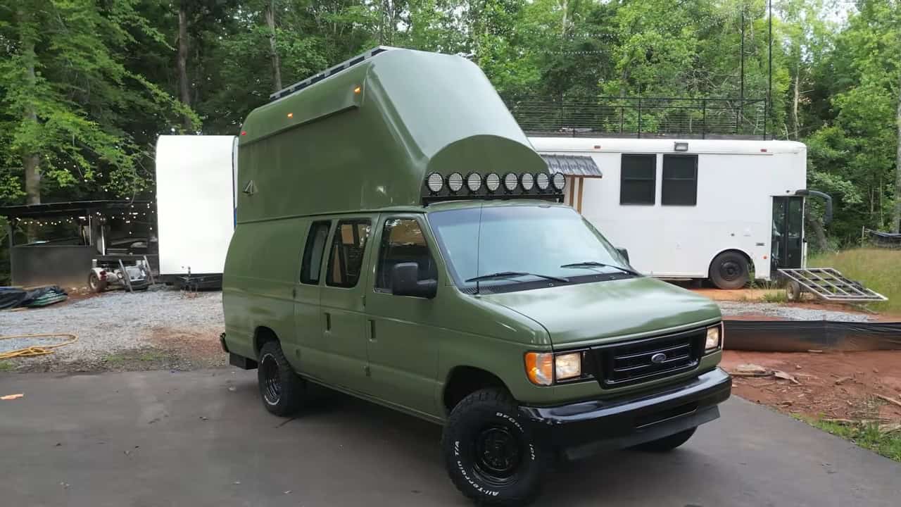 Original white Ford E350 cargo van before the two-story conversion