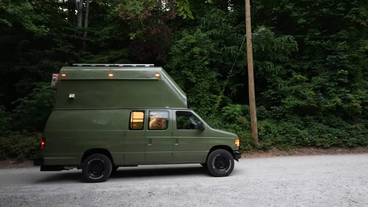 Side profile of the finished olive-green two-story van