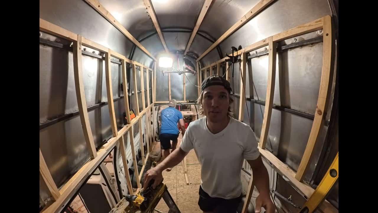 Wood furring strips framing the curved interior walls of the van