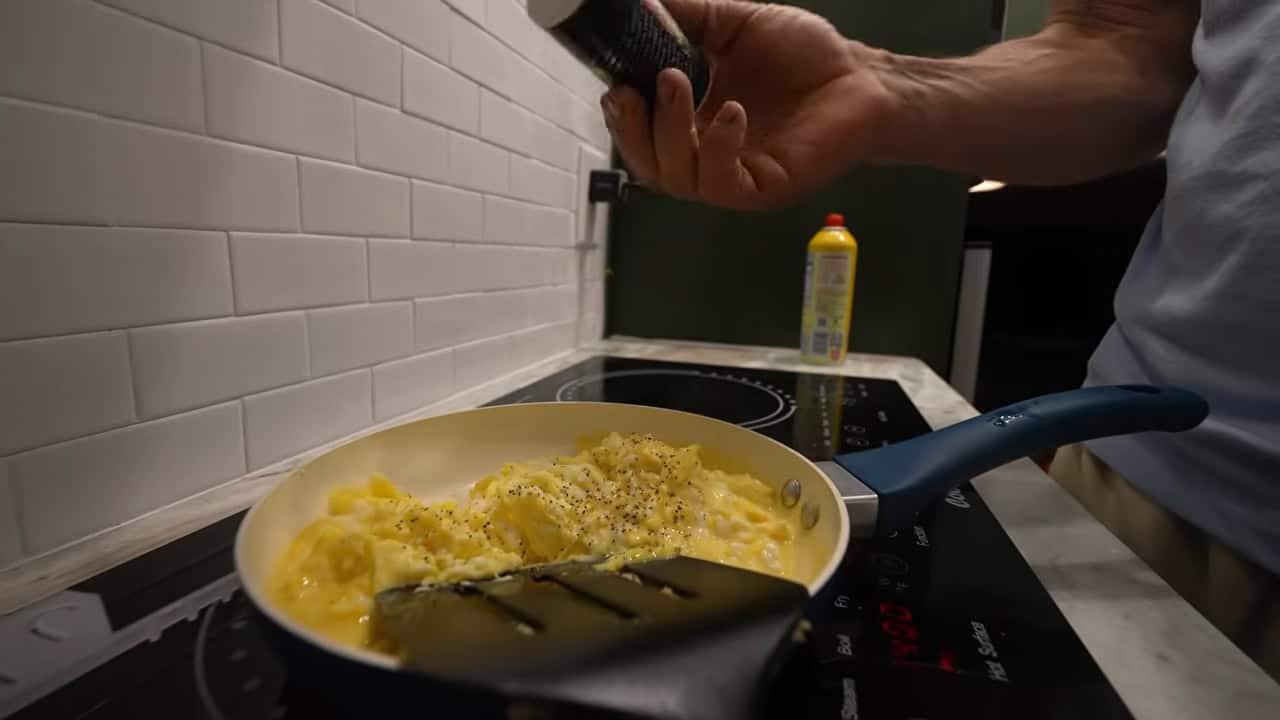 Cooking scrambled eggs on the induction cooktop in the van kitchen
