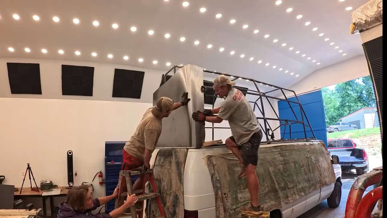 Builders attaching sheet metal skin to the second-story frame
