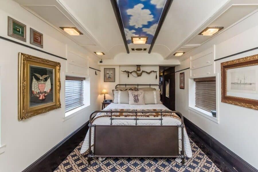 Pullman train car tiny house interior with vintage decor and modern amenities.