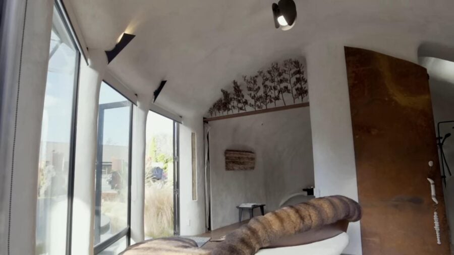 Cozy strawbale tiny house interior with natural light and minimalist decor.