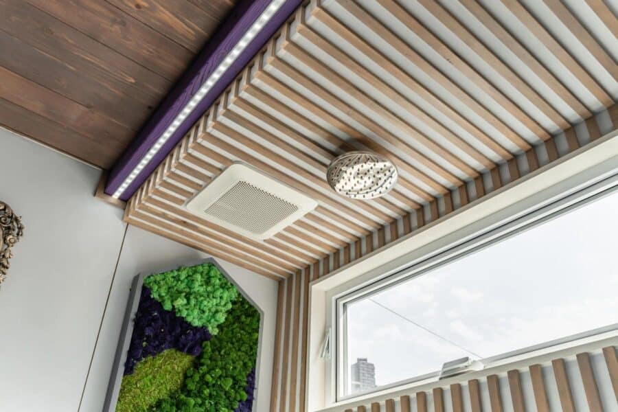 Modern tiny house ceiling with wooden slats and LED lighting.