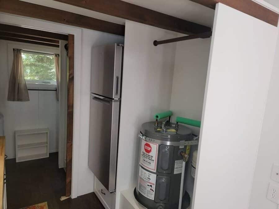Interior of Alki Tiny House showcasing compact kitchen and efficient space utilization.