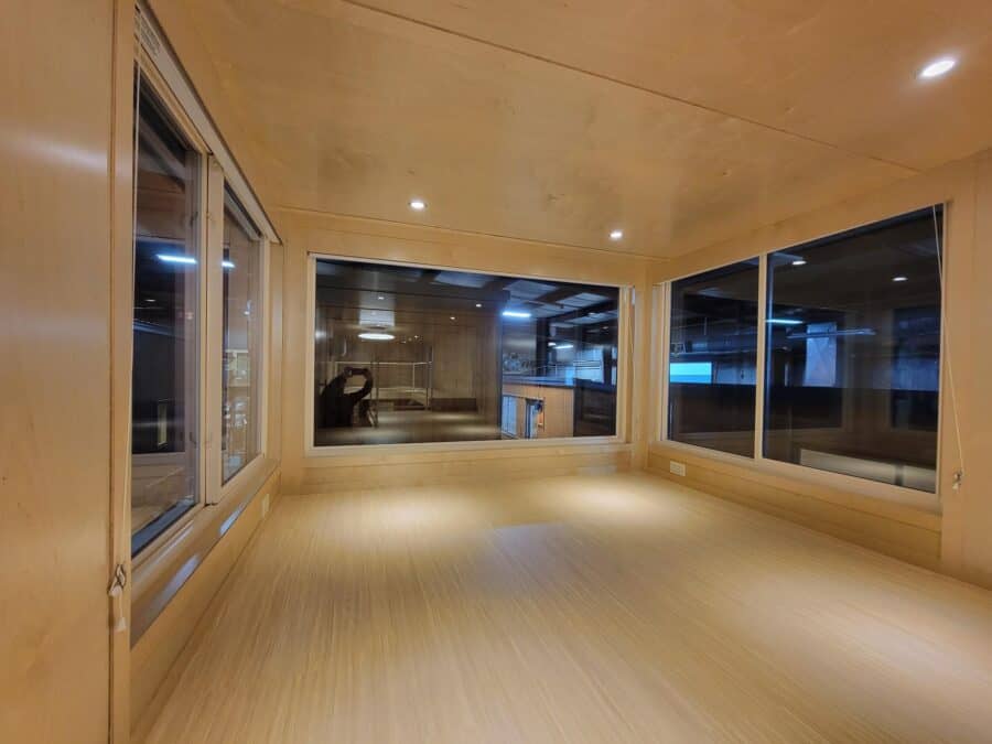 Oversized windows in a tiny house interior for natural light and spacious feel.