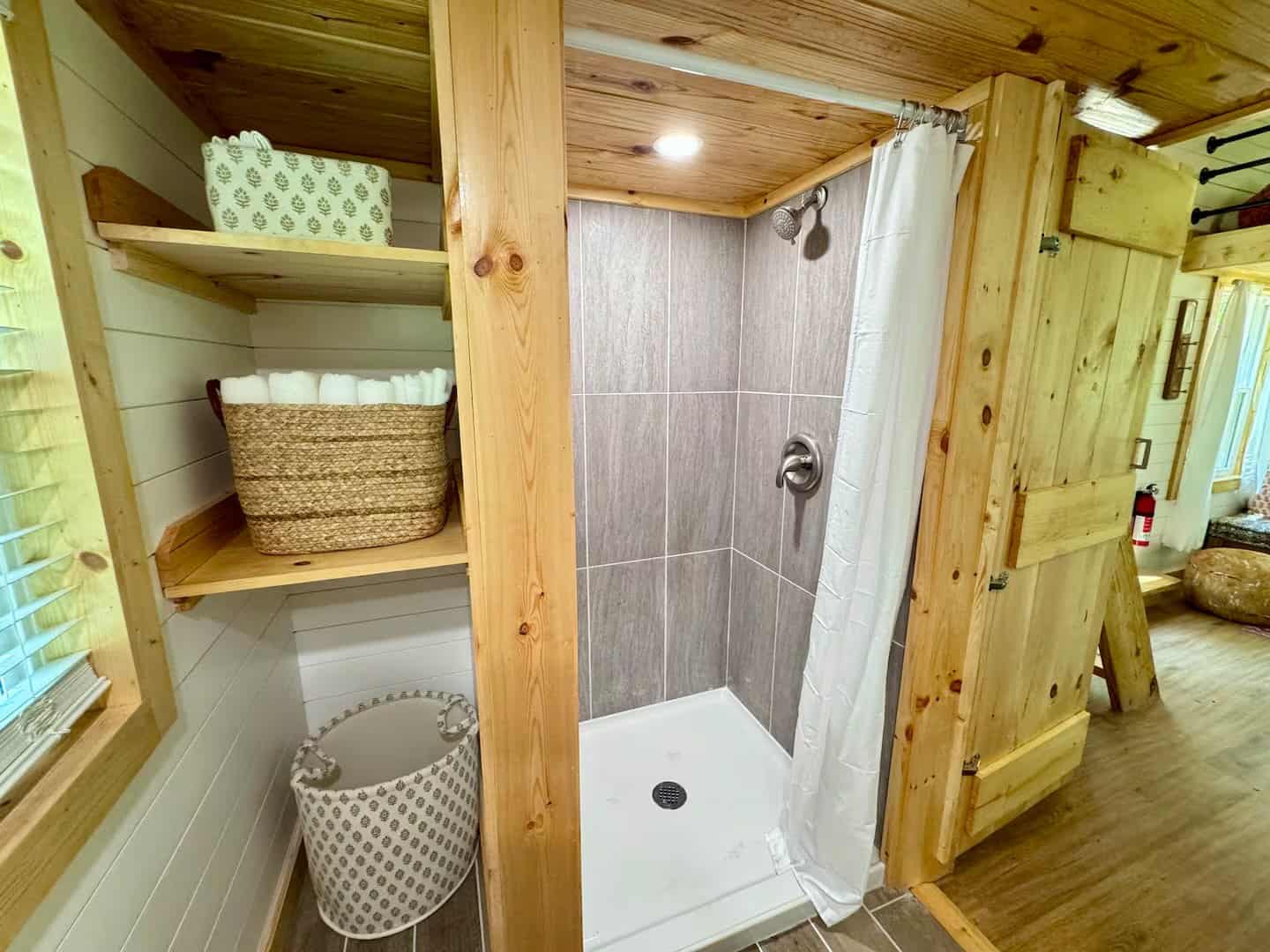 Full-size tiled walk-in shower in the Rasa tiny home bathroom