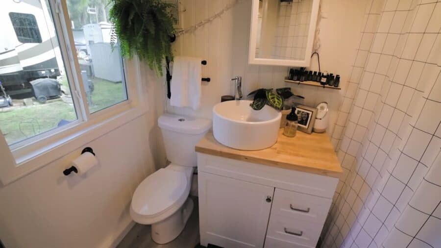 Tiny house bathroom with vessel sink vanity and flush toilet