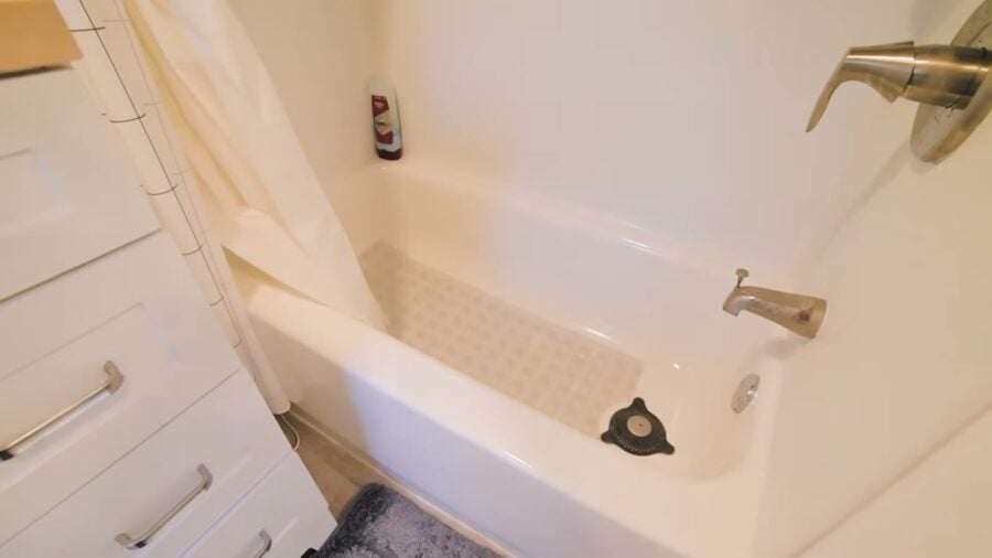 Compact soaking tub with shower in a tiny house bathroom