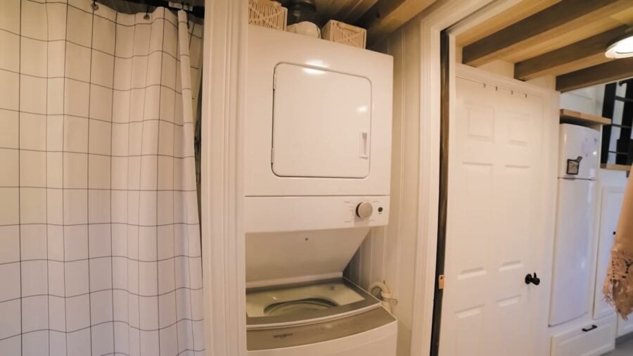 Stackable washer and dryer inside a tiny house bathroom