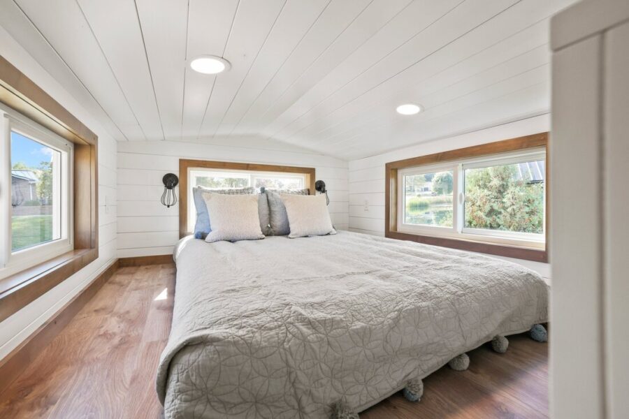 Bright tiny house bedroom featuring natural light and minimalist decor.