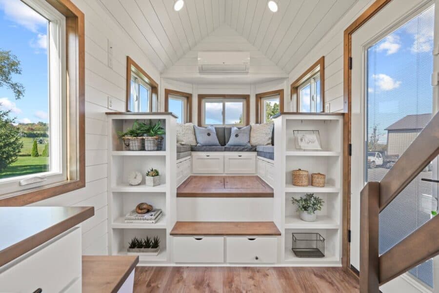 Bright tiny home interior with built-in seating and storage.