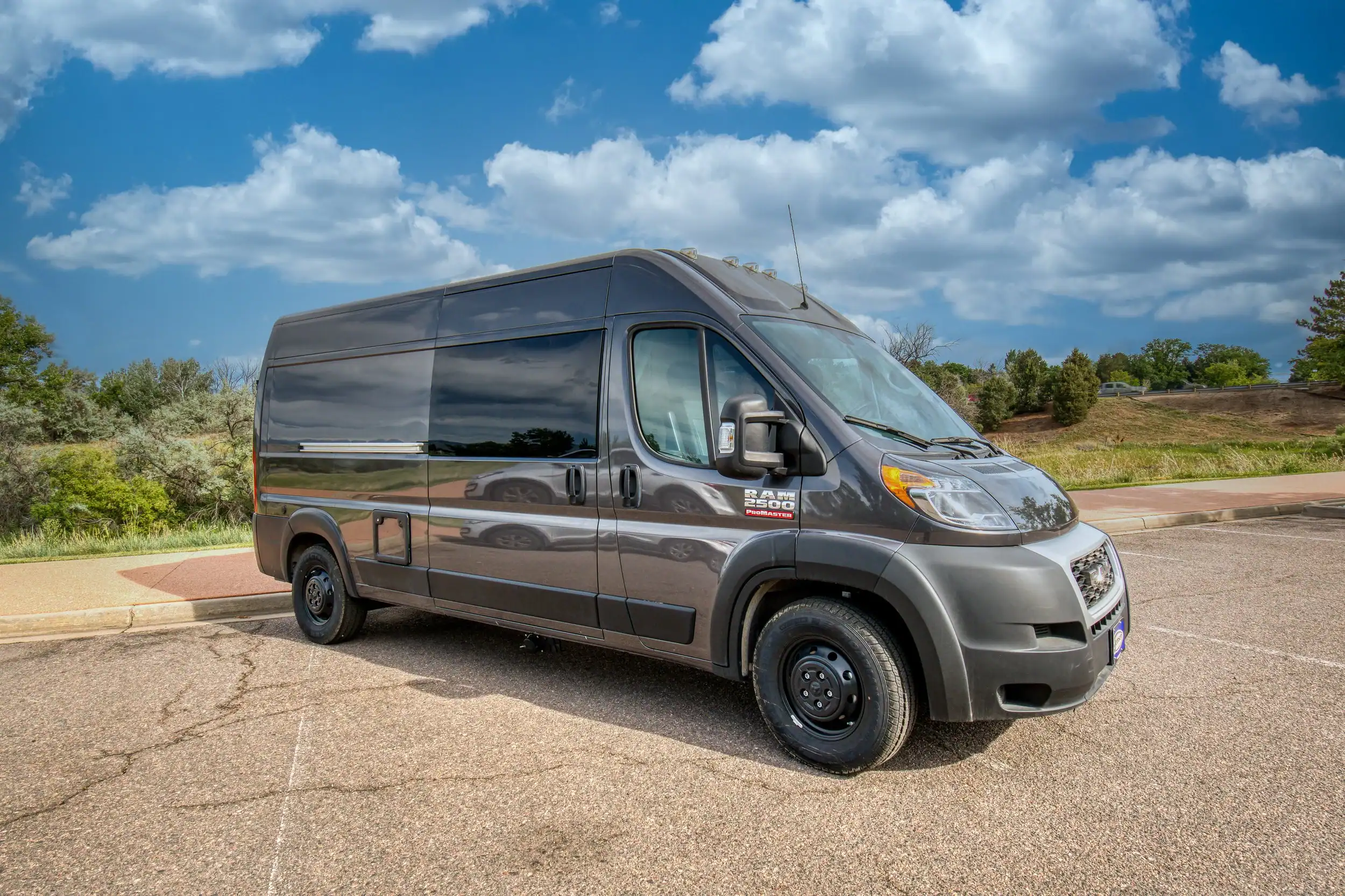 Roameo ProMaster 159 interior showing galley kitchen with fridge and microwave