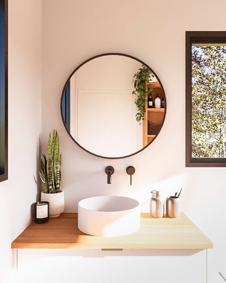 Modern tiny house bathroom with round vessel sink and minimalist decor.