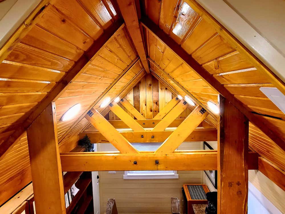 Exposed varnished timber roof trusses and peaked ceiling inside the Rolling Bear Honeycomb Mobile Office