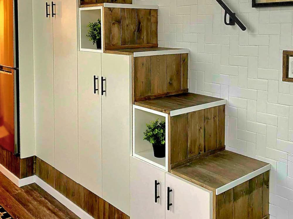 Built-in storage staircase in the Koala Bear with cabinets and open cubbies built into each step