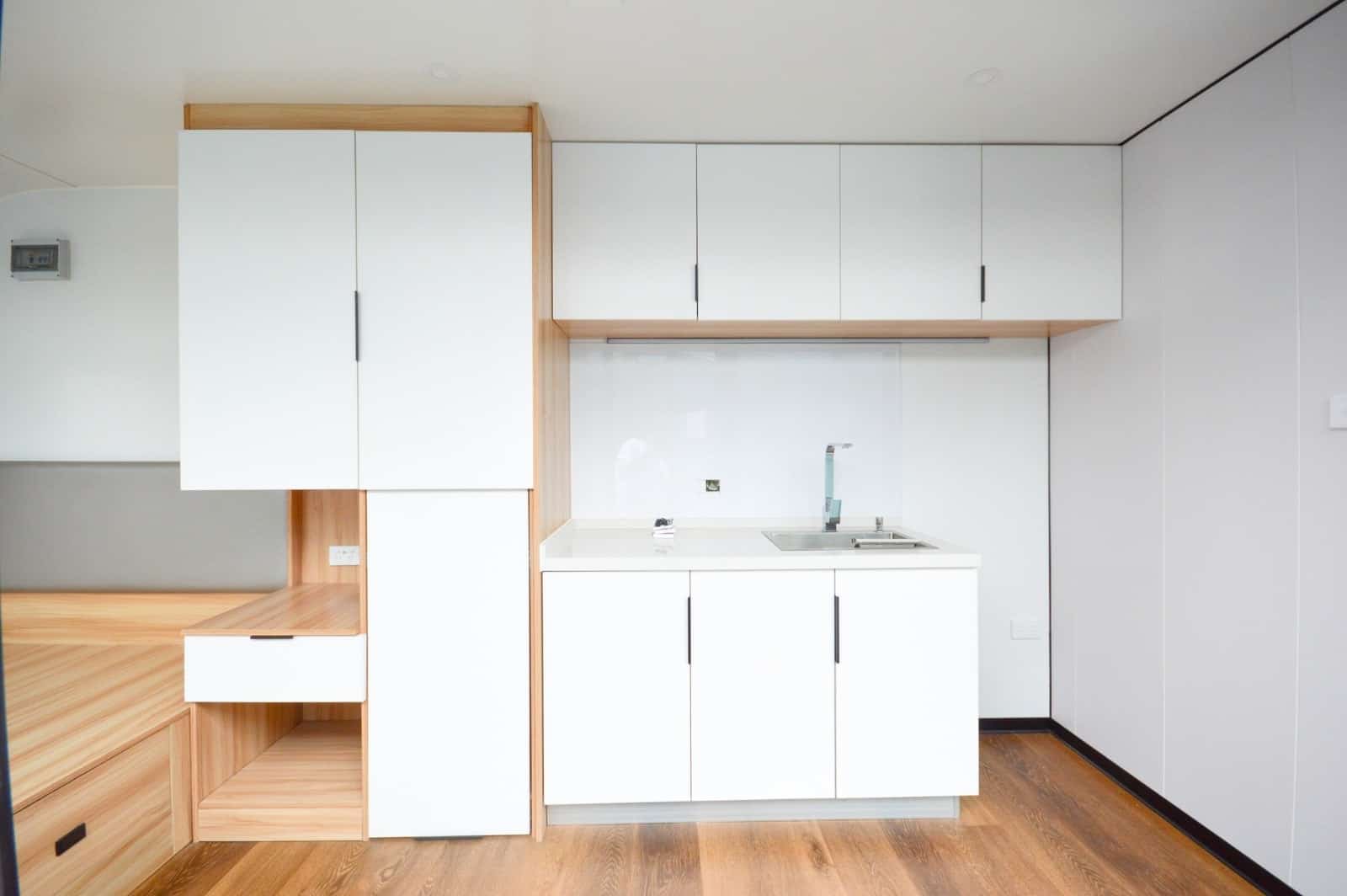 Wet-dry separated bathroom inside RUMI PODS studio tiny home with shower, toilet, and sink