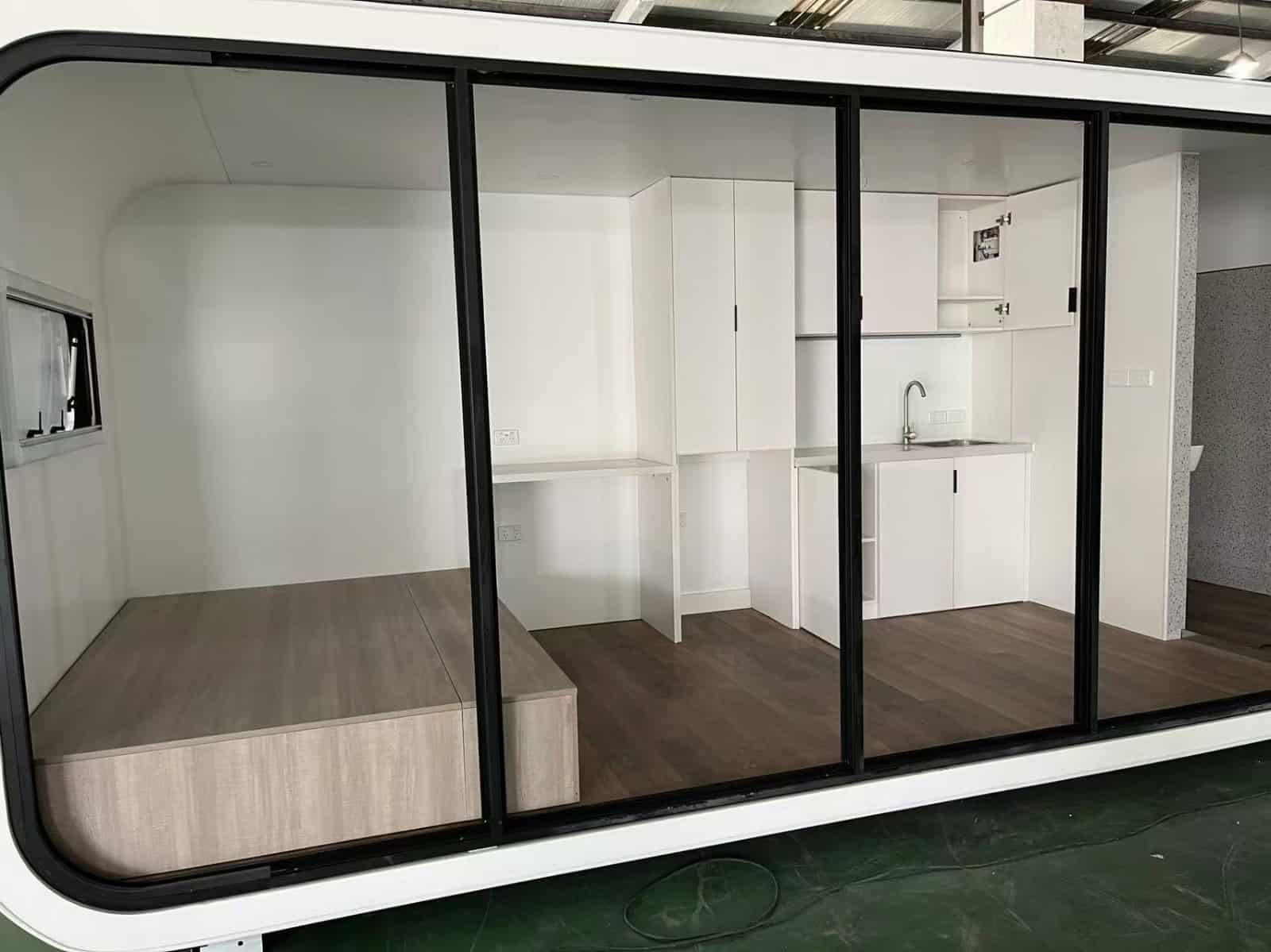 Kitchenette with cabinetry and sink provision inside RUMI PODS studio tiny home