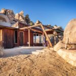 Rustic Tiny Cabin Nestled into Rocky Hillside 001